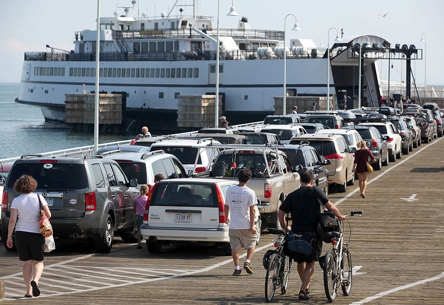 ** FILE ** Passengers with cars and bicycles prepare to board a ferry departing the island of Martha's Vineyard, in Oak Bluffs, Mass., Friday, Aug. 26, 2011. (AP Photo/Steven Senne)