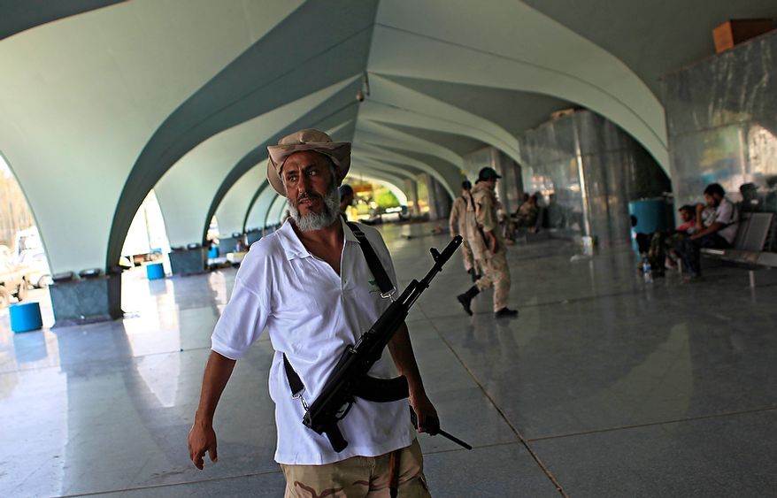 Rebel fighters at Tripoli International Airport outside Tripoli, Libya, Friday, Aug. 26, 2011. British warplanes struck a large bunker Friday in Moammar Gadhafi's hometown of Sirte, his largest remaining stronghold, as NATO turned its attention to loyalist forces trying to hold back advancing Libyan rebels in the area. (AP Photo/Sergey Ponomarev)