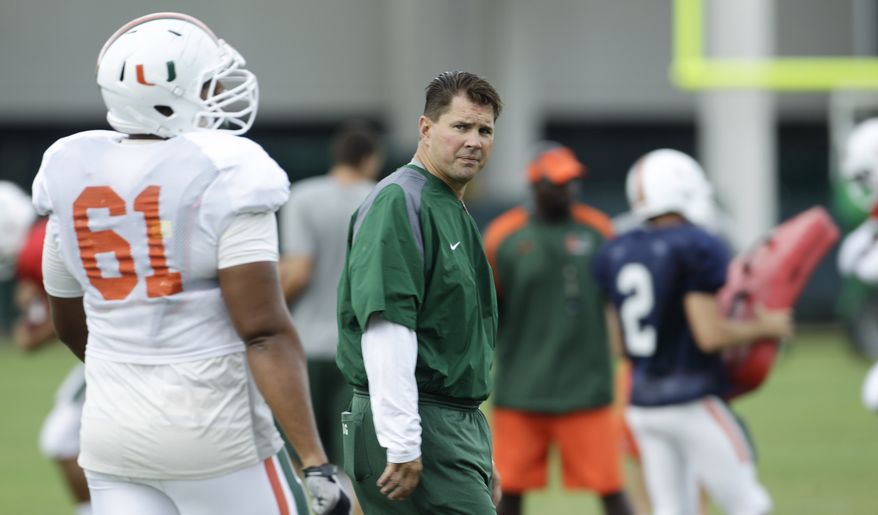 Miami football coach Al Golden walks through his team's practice session Thursday, Aug. 25, 2011 in Coral Gables, Fla. "We'll make sure we practice enough guys because we really don't know what the future brings," Golden said. "Hopefully we'll find out pretty quickly here in the near future if there are any penalties or suspensions, and we'll adjust accordingly." (AP Photo/J Pat Carter)