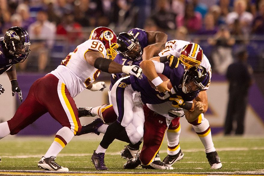 Ryan Kerrigan, Barry Cofield, and Trent Williams of the Washington Redskins take down quarterback Joe Flacco of the Baltimore Ravens in  preseason football at M&amp;T Bank Stadium in Baltimore, MD, Thursday, August 25, 2011. (Andrew Harnik / The Washington Times)