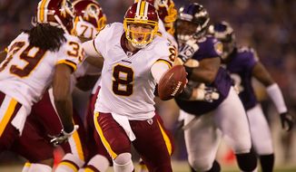 Quarterback Rex Grossman of the Washington Redskins hands off to Dante Barnes in preseason football at M&amp;T Bank Stadium in Baltimore, MD, Thursday, August 25, 2011. (Andrew Harnik / The Washington Times)