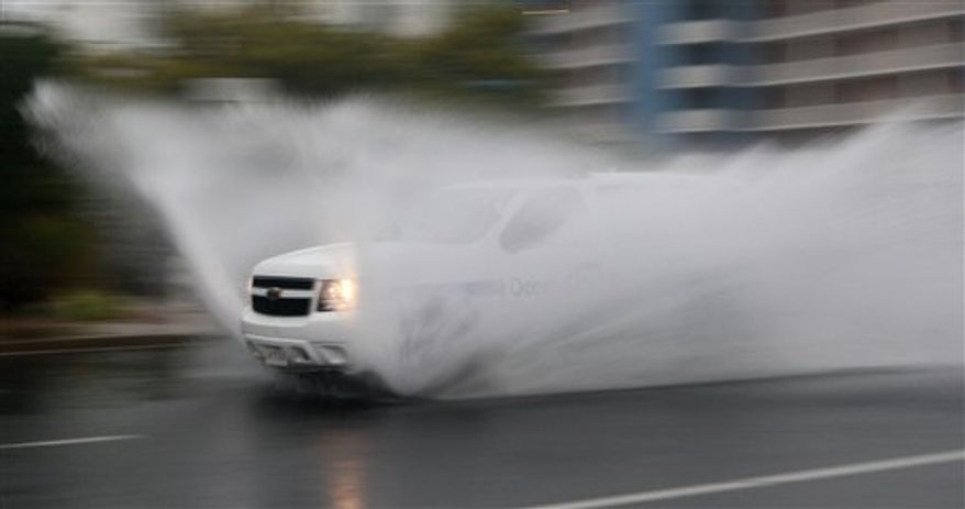 An Ocean City Police Department vehicle makes its way down Philadelphia Avenue in Ocean City, Md., Saturday, Aug. 27, 2011, as Hurricane Irene heads toward the Maryland coast. (AP Photo/Patrick Semansky)