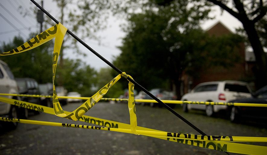 A line is down and taped off at the corner of Jefferson and S. Lee Streets in Old Town Alexandria, Va, Sunday, August 28, 2011. As Hurricane Irene makes her exit from the region and points northbound along the Atlantic coast, people start the process of cleaning up after the category one hurricane (Rod Lamkey Jr./The Washington Times)