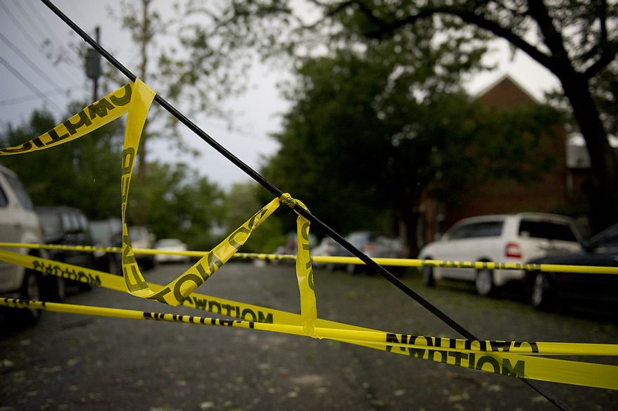 A line is down and taped off at the corner of Jefferson and S. Lee Streets in Old Town Alexandria, Va, Sunday, August 28, 2011. As Hurricane Irene makes her exit from the region and points northbound along the Atlantic coast, people start the process of cleaning up after the category one hurricane (Rod Lamkey Jr./The Washington Times)