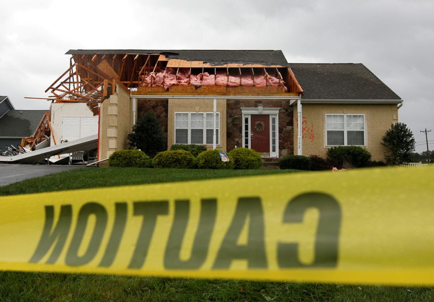 Caution tape hangs in front of a house that was heavily damaged by a possible tornado in Lewes, Del., Sunday, Aug. 28, 2011, after Hurricane Irene churned along the Delaware coast overnight. (AP Photo/Patrick Semansky)