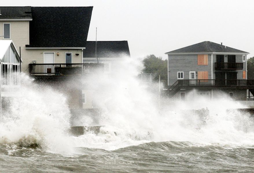 Waves crash along a seawall as Tropical Storm Irene, downgraded from a hurricane, slammed into Fairhaven, Mass. Sunday, Aug. 28, 2011. (AP Photo/Winslow Townson)