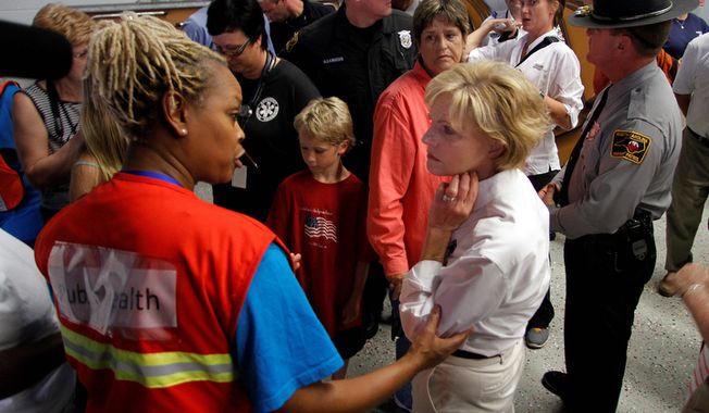 North Carolina Governor Bev Perdue, right, speaks with an Red Cross worker about damage Hurricane Irene left behind in Trenton, N.C., Sunday, Aug. 28, 2011. (AP Photo/Jim R. Bounds)