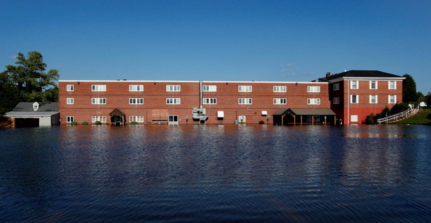 A building is flooded by water that rose above the banks of the St. Jones River in Dover, Del., Sunday, Aug. 28, 2011, after Hurricane Irene dumped several inches of rain along the Delaware coast overnight. (AP Photo/Patrick Semansky)