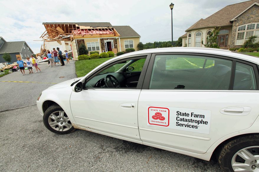 A State Farm Catastrophe Services vehicle is parked out front as people look over the damage to Sue and Jack Holloway's home on Crab Apple Court in the Nassau Station development in Lewis, Del., on Sunday. A poll found that just 14 percent of homeowners had a flood insurance policy. The lowest coverage was in a region hit by Irene: The Northeast, with 5 percent. The highest coverage rate was in the South, with 19 percent. (Associated Press)