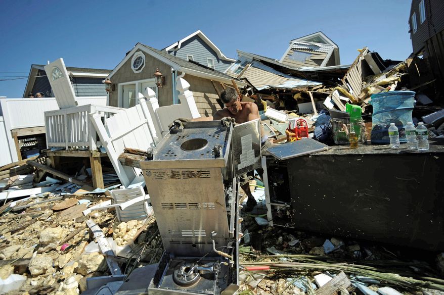 ASSOCIATED PRESS
Richard Filipelli removes a grill from the debris of his home in East Haven, Conn. on Monday after Tropical Storm Irene blew through over the weekend. Downgraded from a hurricane, Irene still packed a punch.