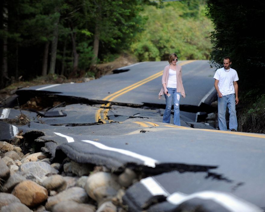 Jarrid Gonyea and his wife Michelle Gonyea of Wilmington , N.Y., check out storm damage on Hurricane Rd. caused by Tropical Storm Irene in the Town of Keene, N.Y., Monday, Aug. 29, 2011. (AP Photo/Hans Pennink)