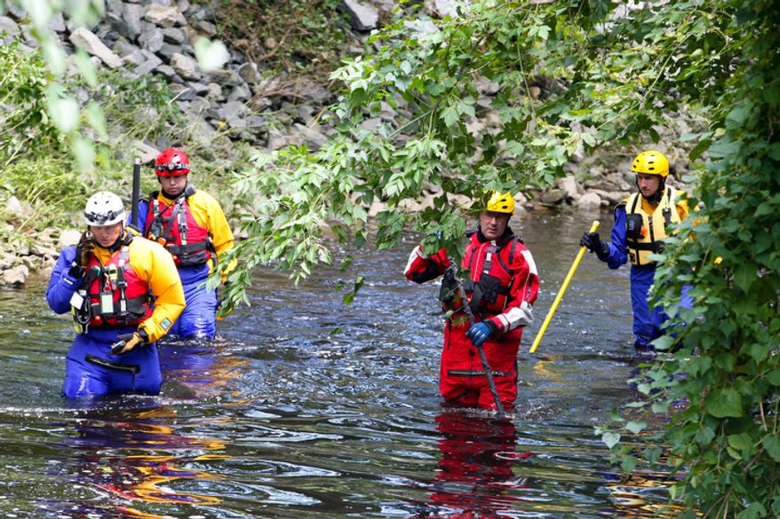 Search and rescue teams search for two Hockessin men who are missing after Hurrican Irene Monday, Aug. 29, 2011 in Hoskessin, Del. New Castle County Police Cpl. John Weglarz says 25-year-old Christopher Valentine of Hockessin and 25-year-old Jean Baptista of Clark, N.J., were last seen around midnight Saturday during the height of the Category 1 hurricane. (AP Photo/The News Journal, Sucha Pederson) NO SALES