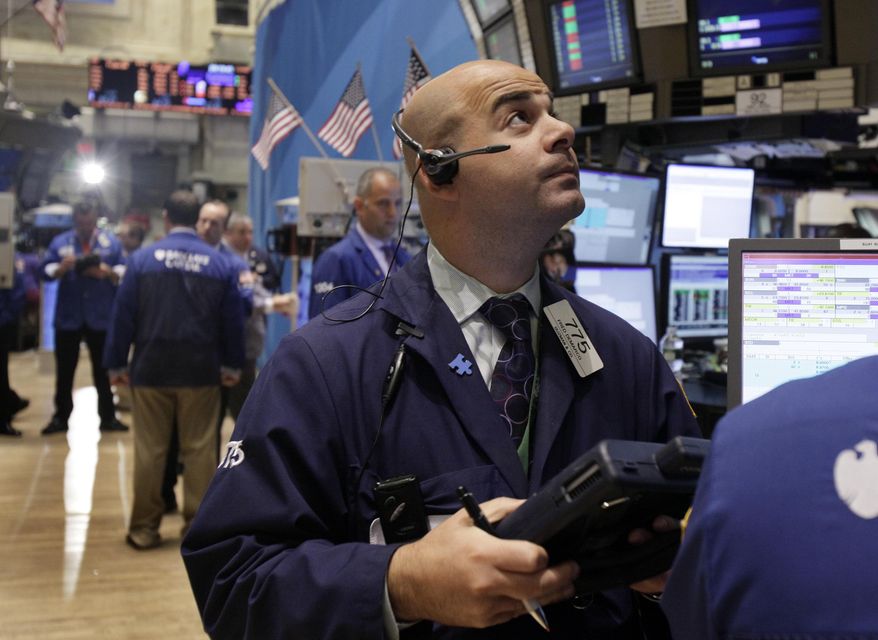 Trader Fred Demarco (right) works on the floor of the New York Stock Exchange on Monday, Aug. 29, 2011, in New York. (AP Photo/Richard Drew)