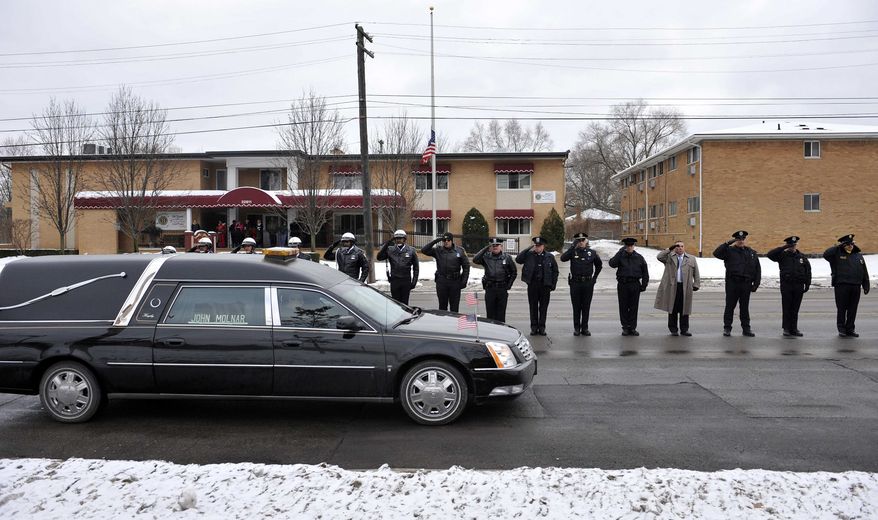 ** FILE ** In this Wednesday, Dec. 22, 2010, picture, a hearse containing the body of U.S. Border Patrol officer and former U.S. Marine Brian Terry drives past a line of law enforcement officers from various departments lined up along Seven Mile Road outside Greater Grace Temple in northwest Detroit after Terry's funeral service. The ATF is under fire over a Phoenix-based gun-trafficking investigation called "Fast and Furious," in which agents allowed hundreds of guns into the hands of straw purchasers in hopes of making a bigger case. Two of those weapons were found in December at the fatal shooting of the Border Patrol agent. (AP Photo/The Detroit News, John T. Greilick)