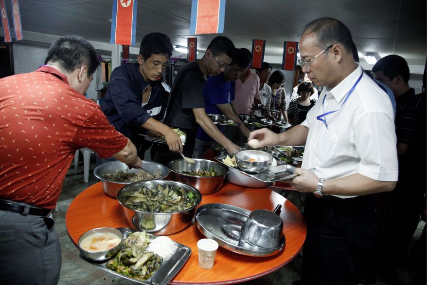 North Koreans and Chinese travel agents enjoy a buffet during the 21-hour trial cruise on the refurbished Japanese-built cargo ship. (Associated Press)