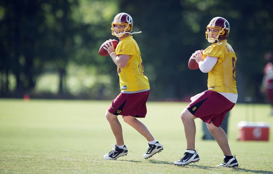 PASSING FANCY: Washington Redskins quarterbacks Rex Grossman (8) and John Beck (12) take part in passing drills during training camp at Redskins Park in Ashburn, Va., on Wednesday. One will be the starting quarterback; the other will take a seat on the bench. (Rod Lamkey Jr./The Washington Times)