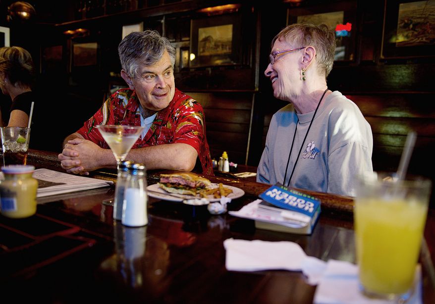 BARBARA L. SALISBURY / THE WASHINGTON TIMES
Phil Panitch and Betty Auman chat over lunch at the Hawk 'n' Dove bar on Capitol Hill on Wednesday, the day its closing was announced. Mr. Panitch, who has been coming to the bar since 1976, said he was "shocked" to hear the news. Ms. Auman, who eats lunch here three out of five days of the workweek, said, "I couldn't believe it. I mean, it's an institution, and it's my lunchtime home with family that I regularly see."