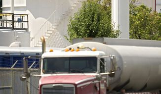ROD A. LAMKEY/THE WASHINGTON TIMES
A tanker truck rolls by a storage tank at the Transmontaigne facility at the Pickett Road tank farm in Fairfax. Federal and state agencies fined Transmontaigne about $114,000 after two spills in 2010.