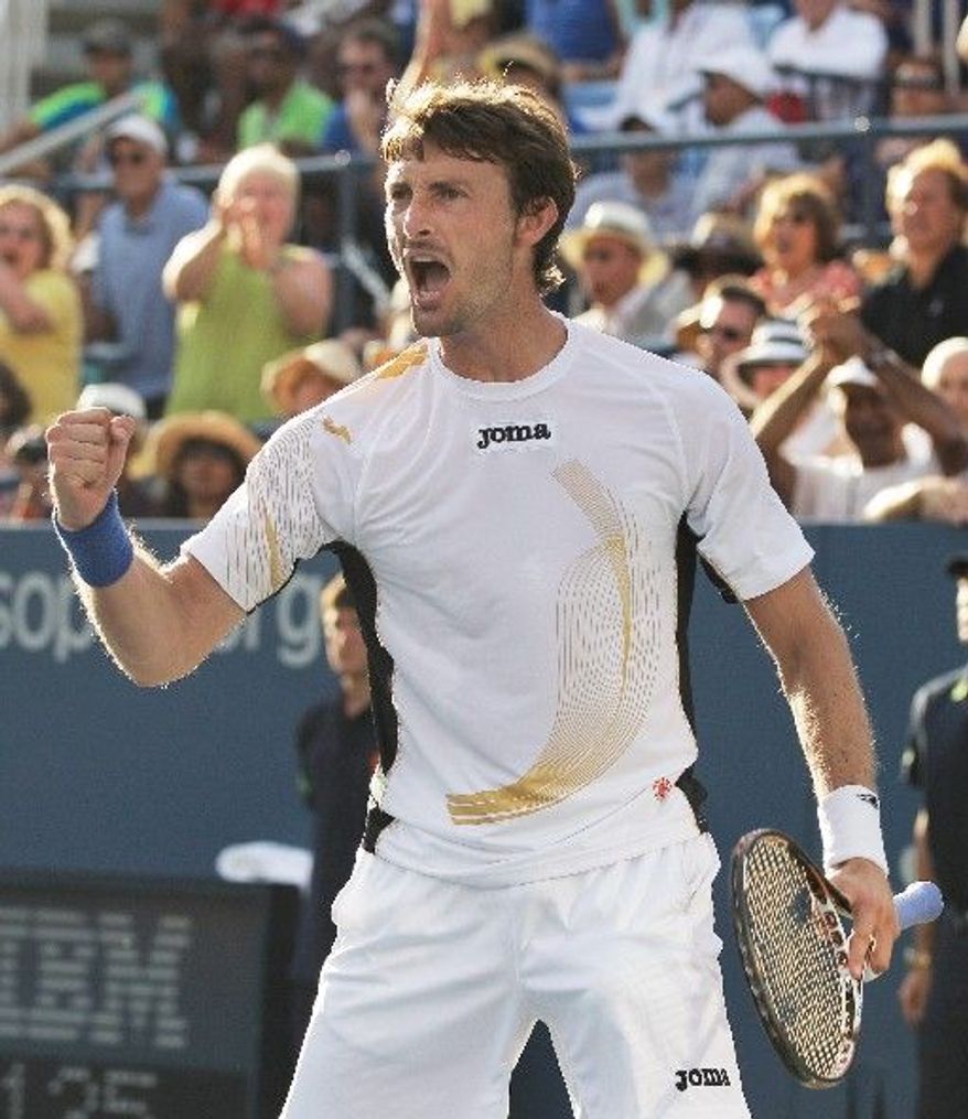 ASSOCIATED PRESS
Juan Carlos Ferrero exults after defeating No. 7 seed Gael Monfils in a five-set, second-round match that lasted nearly five hours.