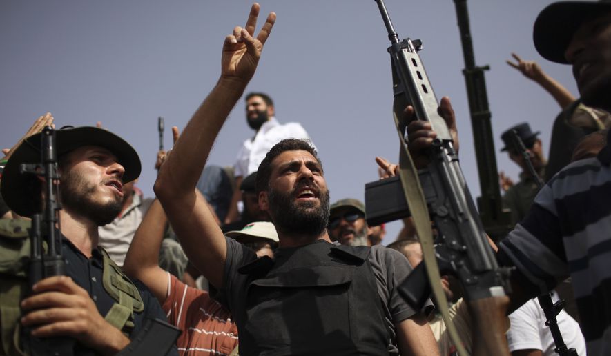 Rebel reinforcements from the Libyan capital of Tripoli celebrate as they arrive at a checkpoint between Tarhouna and Bani Walid, Libya, on Monday, Sept. 5, 2011. (AP Photo/Alexandre Meneghini)