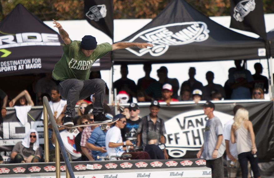 Top-seeded Andrew Reynolds of Hollywood, Calif., does a trick in midair during the final rounds of the skateboarding event. (Pratik Shah/The Washington Times)