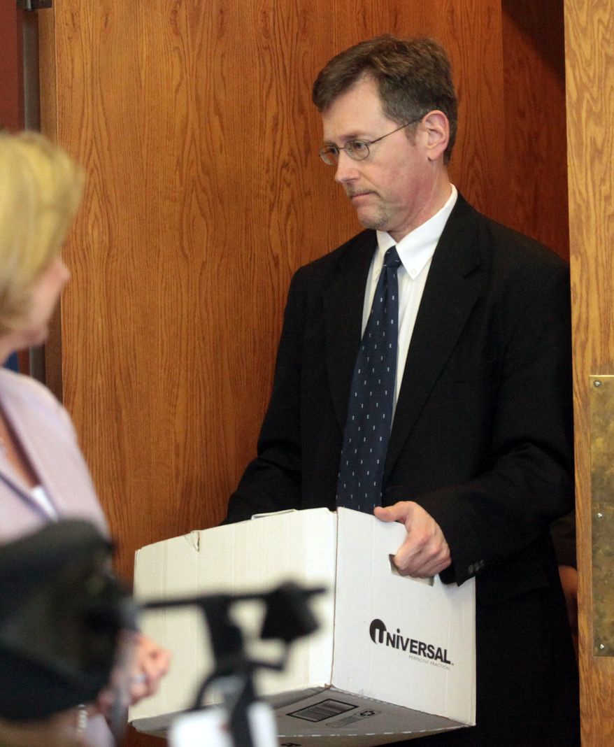 ** FILE ** Ernest Willis carries his lawyers' documents as he enters Merrimack Superior Court in Concord, N.H., on Thursday, May 26, 2011, the fourth day of his trial on charges that he raped his children's 15-year-old babysitter in 1997. (AP Photo/Alexander Cohn, Pool, File)
