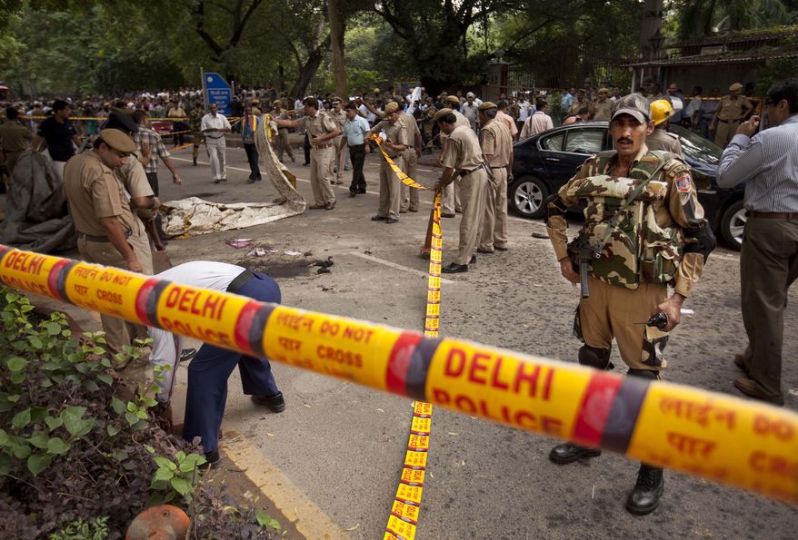 Indian police secure the scene of a blast outside the High Court in New Delhi on Sept. 7, 2011. A bomb apparently hidden in a briefcase exploded outside a gate crowded with petitioners waiting to enter the building. (Associated Press)