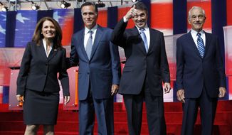 ** FILE ** Republican presidential candidates Michele Bachmann, left, Mitt Romney, second from left, Rick Perry, second from right, and Ron Paul stand together before a Republican presidential candidate debate at the Reagan Library Wednesday, Sept. 7, 2011, in Simi Valley, Calif. (AP Photo/Chris Carlson)