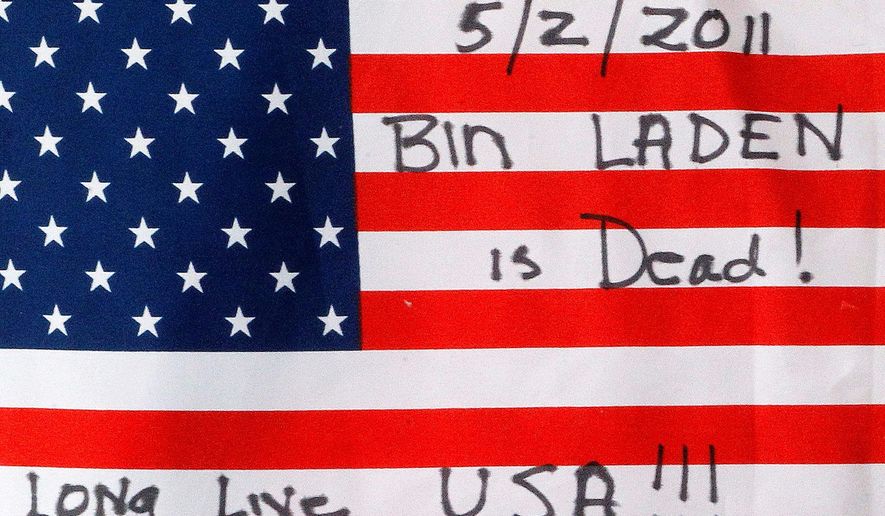 ASSOCIATED PRESS PHOTOGRAPHS
A flag noting the killing of Osama bin Laden is placed at the temporary memorial in Shanksville, Pa., to the pasengers who were killed while stopping terrorists aboard United Airlines Flight 93 on May 2.