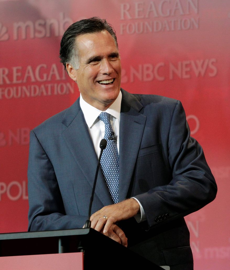Republican presidential candidate Mitt Romney shares a light moment Wednesday during the Republican presidential candidate debate at the Reagan Library in Simi Valley, Calif. For now, he has relinquished his front-runner status to main rival Texas Gov. Rick Perry. (Associated Press)