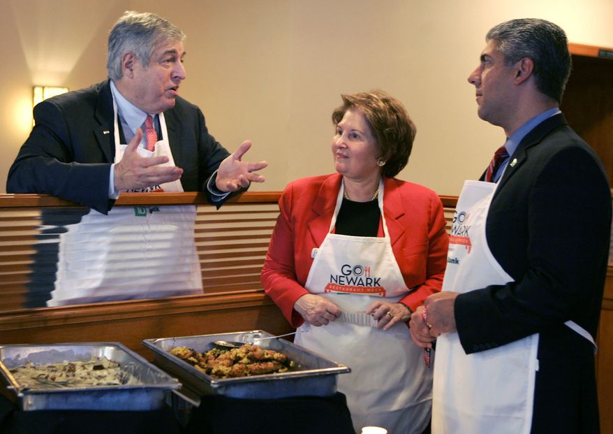 ** FILE ** Tim Zagat (left) and his wife, Nina Zagat, the founders of the restaurant review service Zagat, talk with Nicholas Mecili, an executive with TD Bank, at 60 Park Place Grill in Newark, N.J., in November 2008. Google announced on Thursday, Sept. 7, 2011, it had purchased the Zagats' firm, but they will remain as co-chairs. (AP Photo/Mike Derer, File)