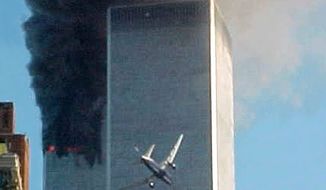 ** FILE ** United Airlines Flight 175 approaches the south tower of the World Trade Center in New York on Sept. 11, 2001, shortly before collision as smoke billows from the north tower. (AP Photo/Carmen Taylor)
