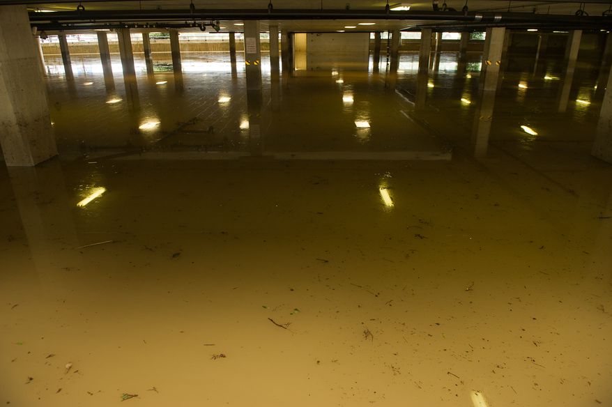 The basement parking lot at Alexandria Tech Center 4 on Eisenhower Avenue in Alexandria, Va., is seen here on Sept. 9, 2011. The lot was flooded after heavy rains pounded the region the previous night. (Andrew Harnik/The Washington Times)