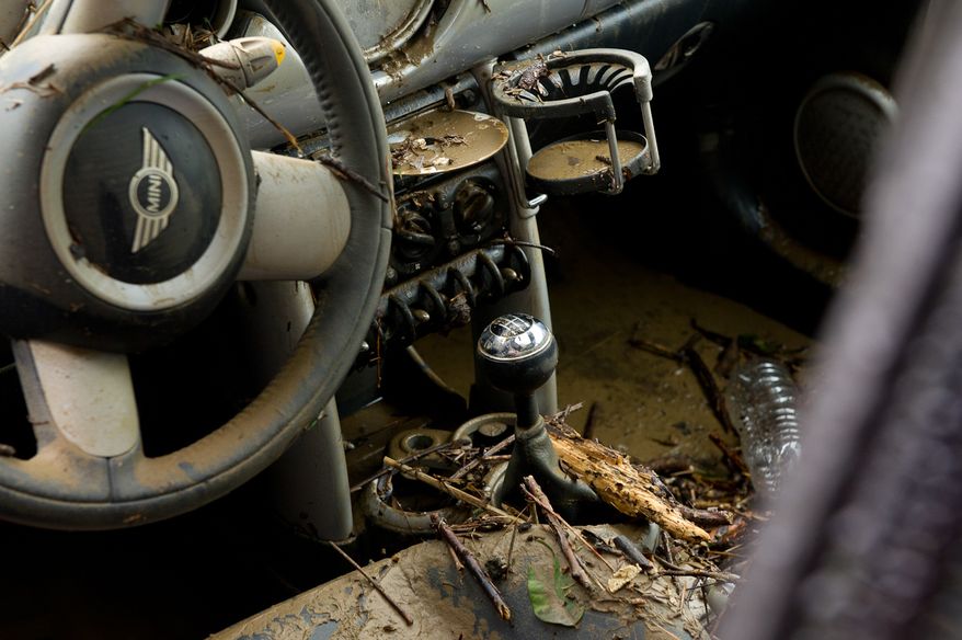 The muddy interior of a Mini Cooper is seen in the parking lot of a Courtyard Marriott hotel on Eisenhower Avenue in Alexandria, Va., on Sept. 9, 2011. The lot was flooded after heavy rains pounded the region the previous night. (Andrew Harnik/The Washington Times)