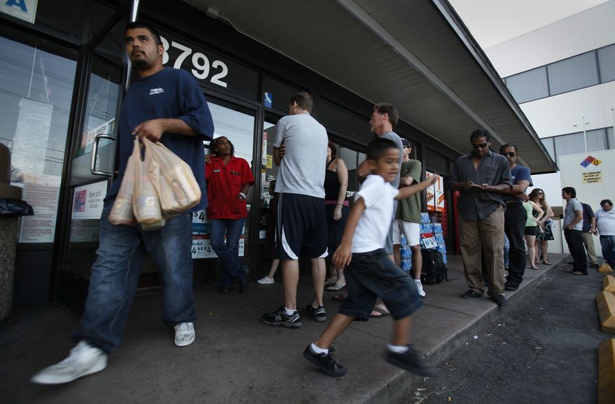 Hugo Camacho, left, and his son Daniel Camacho, 5, emerge from a 7-11 with Gatorade and Cheetos late Thursday, Sept. 8, 2011, in San Diego. The store was only letting only a few customers in at a time and limiting the number of items they could purchase since transactions had to be cash. A power outage accidentally triggered by an Arizona utility company worker darkened a broad swath of the Southwest and Mexico on Thursday. (AP Photo/The San Diego Union-Tribune, Peggy Peattie)