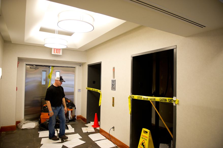 Don Simpson, owner of Simpson Development, looks at the lobby of one of his properties, Alexandria Tech Center II, along Eisenhower Avenue in Alexandria, Va., on Sept. 9, 2011. The property, which had flood waters in its elevators, lobby and parking lot, was built with a first-floor parking lot so that office spaces wouldn't be damaged by flooding, Mr. Simpson said. (Andrew Harnik/The Washington Times)
