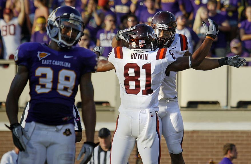 Virginia Tech's Josh Oglesby, right rear, celebrates his go -head touchdown with teammate Jarrettt Boykin (81) as East Carolina's Trent Tignor (38) walks away during the second half of an NCAA college football game in Greenville, N.C., Saturday, Sept. 10, 2011. Virginia Tech won 17-10. (AP Photo/Karl DeBlaker)