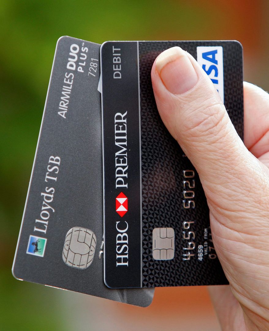 ASSOCIATED PRESS
Two bank smartcards displayed in London have built-in chips. The cards are recognizable by the fingernail-sized gold contacts embedded on one side.