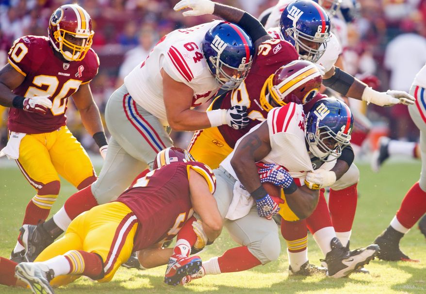 Redskins defenders stop Giants running back Ahmad Bradshaw for no gain at the end of the second quarter at FedEx Field. Bradshaw finished with 44 yards on 13 carries. (Rod Lamkey Jr./The Washington Times)