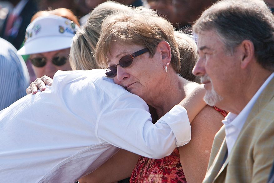 Patricia Fallon (center) of Woodbridge, Va., receives a hug from her grandson Kahleb Fallon, 10, during the commemoration of the Sept. 11, 2001, attack on the Pentagon at the Pentagon Memorial in Arlington on Sunday, Sept. 11, 2011. The Fallons lost Patricia's daughter and Khaleb's mother, Navy SK3 Jamie Fallon, in the attack.
(T.J. Kirkpatrick/The Washington Times)