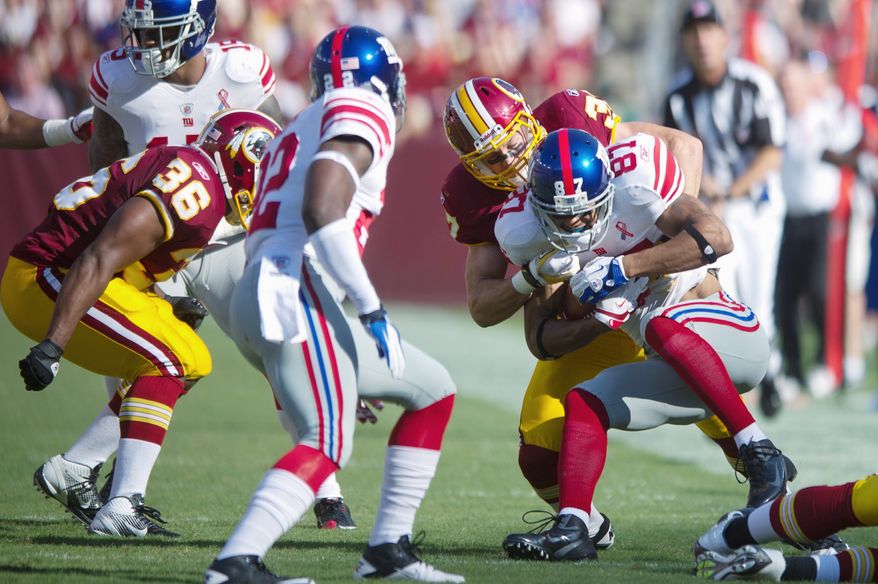 Redsklns safety Reed Doughty had a team-high 10 tackles against the Giants in Sunday's win, but he was caught out of position a couple of times. (Andrew Harnik/The Washington Times)