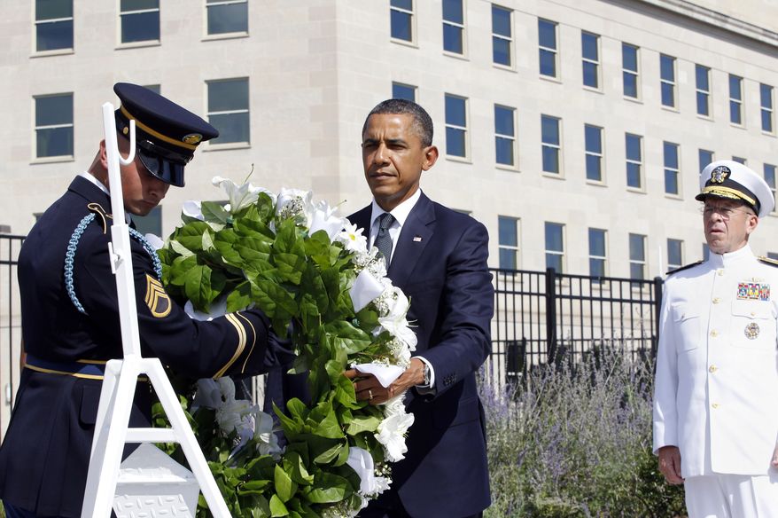 President Obama lays a wreath as the 10th anniversary of the Sept. 11 attacks are observed at the Pentagon in Arlington on Sunday, Sept. 11, 2011. At right is Adm. Mike Mullen, chairman of the Joint Chiefs of Staff. (AP Photo/Charles Dharapak)