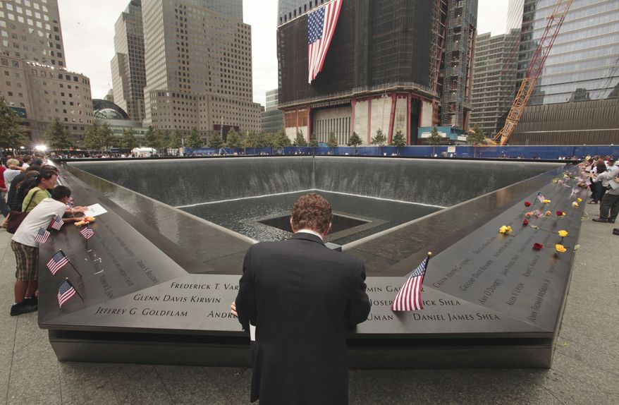 Michael Lehrman, executive managing director of Cantor Fitzgerald and Co., bows his head at one of two memorial pools at ground zero in New York on Sunday, Sept. 11, 2011, the 10th anniversary of the Sept. 11 attacks. More than 600 employees from Cantor Fitzgerald lost their lives in the attacks on the World Trade Center's twin towers. (AP Photo, Carolyn Cole, Pool)