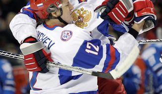 Defenseman Dmitry Orlov (right) , a 20-year-old prospect in the Capitals organization, celebrates a goal for Russia during the World Junior Hockey Championship in January. (Associated Press)
