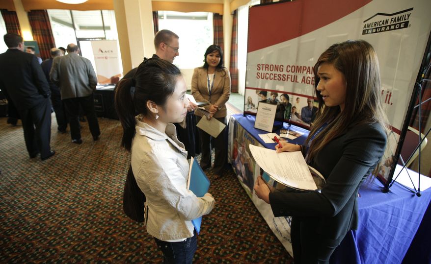 Lihn Phung (left), a senior at Eastern Washington University, talks to Lieu Vo, an agency sales manager assistant with American Family Insurance, about internship opportunities during a National Career Fairs job fair on Sept. 14, 2011, in Bellevue, Wash. (Associated Press)