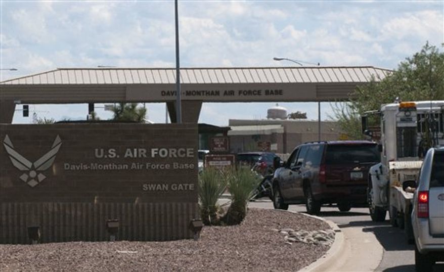 Vehicles are stopped outside an entrance to Davis-Monthan Air Force Base in Tucson, Ariz., Friday, Sept. 16, 2011, after a report of a man with a gun prompted panic and reports that someone had been shot at the sprawling military facility. Traffic into and out of the base was limited because of the security situation, but no one was shot or hurt, according to the public affairs office at the base. (AP Photo/Gary M. Williams)