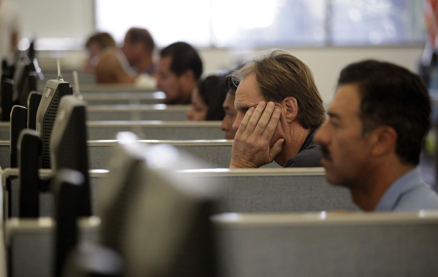 Dave Traweek, second from right, who has been unemployed for nearly two years, looks for a job at the Orange County One-Stop Center in Westminster, Calif., Thursday, Sept. 8, 2011. (AP Photo/Jae C. Hong)