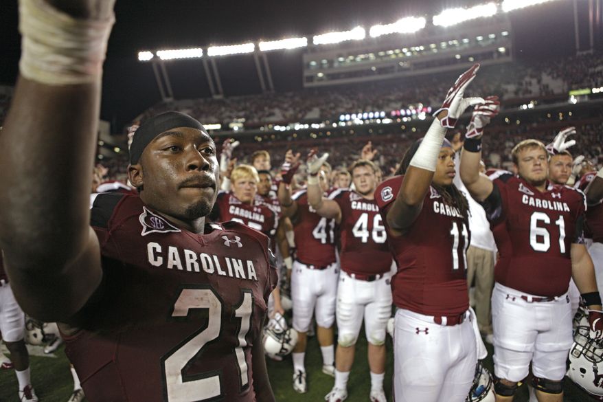 South Carolina running back Marcus Lattimore salutes the alma mater after South Caroina's 24-21 vicory over Navy. Lattimore rushed for 246 yards and three touchdowns. (AP Photo/Brett Flashnick)
