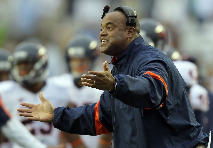 Virginia coach Mike London directs his team during the second half of an NCAA college football game against North Carolina in Chapel Hill, N.C. on Saturday, Sept. 17, 2011. North Carolina won 28-17. (AP Photo/Gerry Broome)