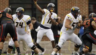West Virginia quarterback Geno Smith threw for a career-high 388 yards in West Virginia&#39;s 37-31 win over Maryland. He had one touchdown and an interception. (Associated Press)